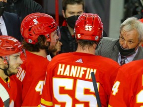 Flames head coach Darryl Sutter offers some instructions to his team during a timeout in a game against the Edmonton Oilers in this photo from March 15, 2021.