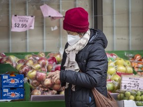 A woman shops for groceries at Toronto's Yao Hua Supermarket on Gerrard Street East on Jan. 19, 2022.