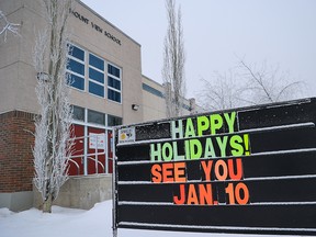 A sign outside Mount View School announces the postponement of return to classes on Monday, Jan. 3, 2022. Alberta has delayed the start date to help schools deal with COVID-19 precautions due the Omicron surge.