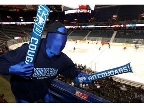 Fan Doug Thomas cheers on his Mount Royal Cougars to no avail during one instalment of the Crowchild Classic.