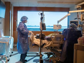 ICU doctor Jamie Spiegelman speaks to a COVID-19 patient before intubation at Humber River Hospital in Toronto on Jan. 20, 2022.