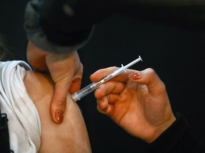 FILE PHOTO: A nurse gives out COVID shots as part of the City of Calgary’s extension of its mobile vaccination outreach program, a short-term COVID-19 vaccination station launched at Southcentre Mall on Monday, January 3, 2022.