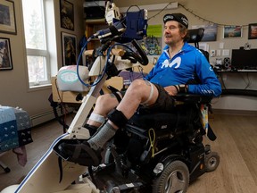 Stewart Midwinter pedals on his stationery bike at his room in Inclusio accessible housing in Calgary to virtually ride around the world. He reached his goal of 40,075km on Feb. 2, 2022.