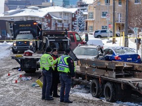 Three people were injured after a large flatbed truck rolled down a hill towards 4th Avenue N.E., hitting two parked vehicles where the three people were standing.