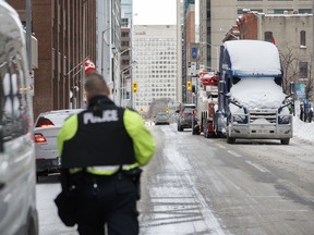 A truck is towed away in downtown Ottawa on Sunday, Feb. 20, 2022, after police worked to clear a trucker protest that was aimed at COVID-19 measures that grew into a broader anti-government protest.