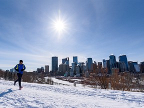 A jogger braves the extremely cold weather in Calgary to go for a run on the pathway at Crescent Heights on Wednesday, February 23, 2022.