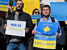 Demonstrators protest against the Russian invasion of Ukraine, in front of the Russian representative office in Pristina on February 25, 2022.