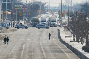 A line of trucks waits for the road to the Ambassador Bridge to reopen after the cross-border bridge was blocked Monday night by anti-mandate protesters.