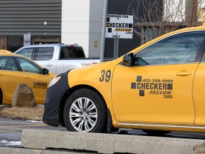 A line of Checker Cabs along Palmer Rd. NE.  Thursday February 17, 2022.
