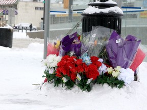 Flowers rest along 17th Ave. and 44th St. SE as a tribute for Latjor Tuel, who died after police shot him when he allegedly attacked a police service dog with a weapon. Sunday, February 20, 2022.