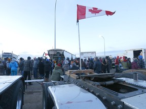 Protesters listen to Premier Jason Kenney at the roadblock on Highway 4 outside of Milk River heading towards the Coutts border crossing on Tuesday, February 8, 2022.