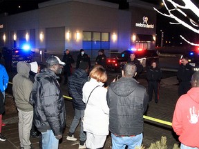 Police on the scene after a man was killed in a police shooting along 17th Ave. SE Bystanders who witnessed the shooting protested against police actions near the scene along 44th St. SE. Saturday, February 19, 2022.