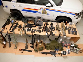 Photo supplied by RCMP on Monday, Feb. 14, 2022, shows a large assortment of weapons and ammunition seized near Coutts during a crackdown near the Canada/U.S. border.