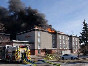 Fire crews battle a blaze at the Ramada Hotel in Cochrane. Sunday, February 6, 2022.