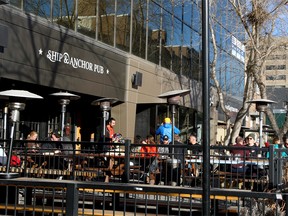 People enjoy the patio at the Ship & Anchor Pub along 17th Ave SW. Wednesday, February 9, 2022.