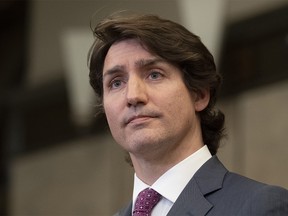Canadian Prime Minister Justin Trudeau listens to a question from a reporter after announcing the Emergencies Act will be invoked to deal with protests on Monday, February 14, 2022 in Ottawa.