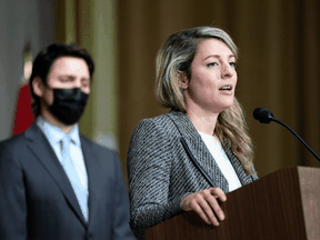 Prime Minister Justin Trudeau listens as Foreign Affairs Minister Mélanie Joly speaks during news conference on the situation in Ukraine, in Ottawa, on Tuesday, February 22, 2022.