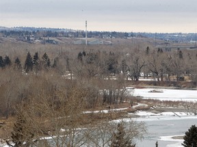 People are seen walking near the Bow River during a chilly afternoon. Saturday, February 19, 2022.