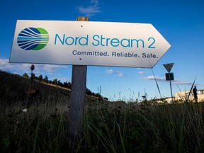 This file photo taken on Sept. 7, 2020 shows a road sign directing traffic towards the Nord Stream 2 gas line landfall facility entrance in Lubmin, north eastern Germany. The Nord Stream 2 pipeline, set to double natural gas supplies from Russia to Germany, was a bargaining chip for the West in its bid to stop Moscow from invading Ukraine. The pipeline, which Germany has defiantly pursued despite criticism from the United States and Eastern Europe, was completed in 2021 but still requires regulatory approval. Germany has now withdrawn approval after the invasion, despite a severe energy crisis that has sent gas prices soaring in Europe.