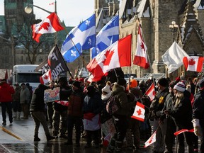 Supporters of the Freedom Convoy protest against COVID-19 vaccine mandates and restrictions gather in front of Parliament January 28, 2022 in Ottawa, Canada.