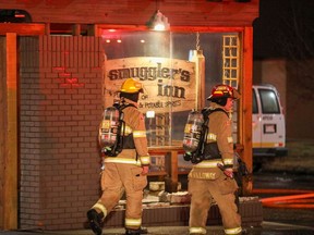Firefighters respond to a fire on the roof of the building which contains Smuggler's Inn and Frank's on Macleod Trail on Monday, Feb. 7, 2022.