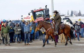 Authorities deal with a road block on Highway 4 and 501 outside of Milk River heading towards the Coutts border, Feb. 3, 2022.