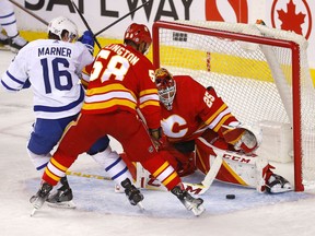 Calgary Flames goalie Jacob Markstrom stops the Toronto Maple Leafs’ Mitchell Marner at Scotiabank Saddledome in Calgary on Thursday, Feb. 10, 2022.