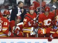 Calgary Flames associate coach Kirk Muller, back left, gives instruction during a game against the New York Islanders at Scotiabank Saddledome in Calgary on Saturday, Feb. 12, 2022.