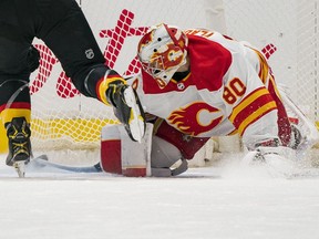 Flames goalie Dan Vladar watches a penalty shot off the stick of Canucks forward J.T. Miller slide into the net in the second period of Thursday night's game at Rogers Arena in Vancouver.