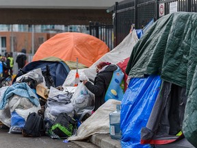 Homeless people at the encampment outside the Calgary Drop-in Centre on Thursday, Feb. 10, 2022.