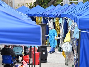 A makeshift camp set up for COVID-19 patients due to limited space inside is pictured outside the Caritas Medical Centre in Hong Kong on Feb. 18, 2022, as the city faces its worst coronavirus wave to date.
