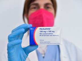 A doctor displays the COVID-19 treatment drug Paxlovid in Grosseto, Italy.