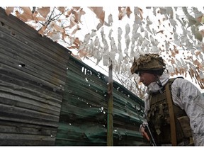 A service member of the Ukrainian armed forces is seen at combat positions near the line of separation from Russian-backed rebels outside the town of Avdiivka in the Donetsk Region, Ukraine February 10, 2022.