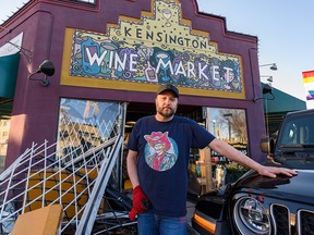 Andrew Ferguson, owner of Kensington Wine Market, poses for a photo outside his store after someone drove a truck through the front entrance early Friday, Feb. 11, 2022.