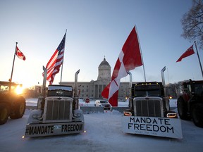 Transport trucks and farm equipment block traffic in front of the Manitoba Legislative Building in Winnipeg on Feb. 4, 2022.