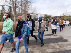 University of Calgary students gather outside the MacEwan Student Center on campus to protest budget cuts and tuition increases Monday, March 28, 2022.