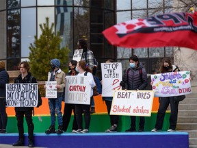 University of Calgary students gather outside the MacEwan Student Center on campus to protest budget cuts and tuition increases Monday, March 28, 2022.