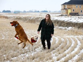 Kim Norrie walks her dogs, Scout and Jayda, near her new home by Broadview Homes in Langdon. Norrie loves the small town feel mixed with the family friendly community, as she and her husband are expecting their first child soon.