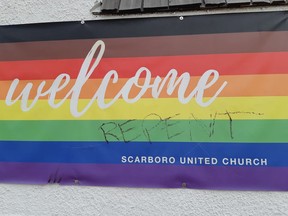 A banner depicting the Pride flag at the Scarboro United Church in Calgary was defaced in March 2022.