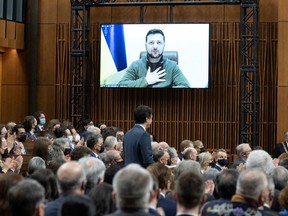 Ukrainian President Volodymyr Zelenskyy places his hand on his chest as he listens to Canadian Prime Minister Justin Trudeau deliver opening remarks before addressing the Canadian parliament, Tuesdayin March 15 in Ottawa. THE CANADIAN PRESS/Adrian Wyld