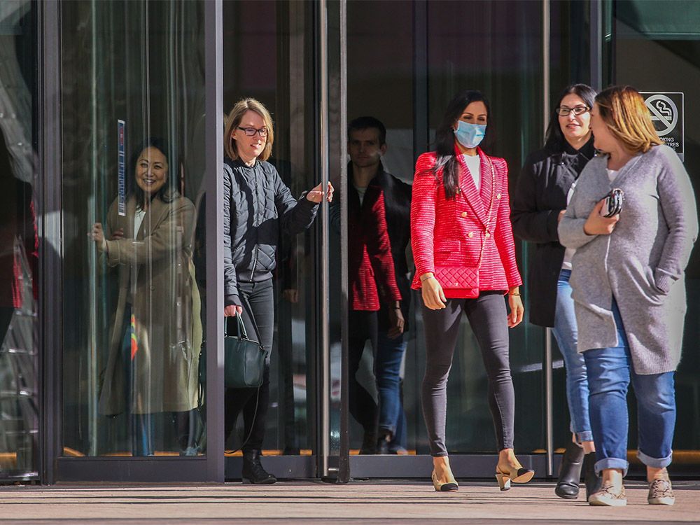 Downtown workers pass through a revolving door at The Bow office tower in Calgary on Wednesday, March 16, 2022.