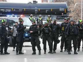 Calgary police prepare to clear Macleod Trail to open it to traffic as anti mandate protesters rally outside City Hall on  Saturday, March 19, 2022. The protesters met in Central Memorial Park and then walked on the sidewalks to City Hall.