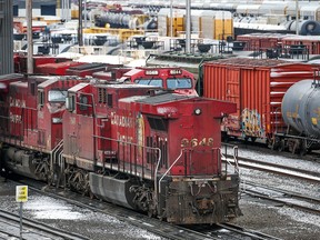 CP Rail trains are seen at the company’s Calgary Alyth Yards on Sunday, March 20, 2022. CP Rail and the union representing 3,000 locomotive engineers, conductors, train and yard workers across Canada have agreed to binding arbitration.