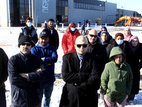 Ahmed Elsaid (centre) is joined by several parents of children who attend Calgary Islamic School, Akram Jomaa Campus.
