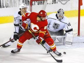 Calgary Flames forward Andrew Mangiapane battles Los Angeles Kings goalie Cal Petersen in first period NHL action at the Scotiabank Saddledome in Calgary on Thursday, March 31, 2022.
