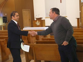 Premier Jason Kenney shakes hands with pastor Thai Nguyen as he announced increased supports for Albertans targeted by hate crimes at the Calgary Vietnamese Alliance Church in Calgary on Sunday, March 13, 2022.