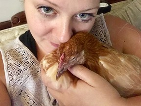 Nikki Pike poses with one of her emotional support hens.