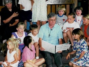 Bill Phipps reads to children in an undated photo.