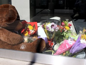 A temporary memorial with flowers and letters for the stabbing victim Vanessa Ladouceur is seen inside a private commercial building near the site of the attack last Friday along 10th Ave SE. March 22, 2022