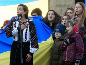 Ukrainian-Canadian singer Stephania Romaniuk performs the Ukrainian national anthem with children for hundreds who have gathered at City Hall to show their solidarity with Ukraine. Romaniuk will perform the Ukrainian national anthem at the Saddledome Monday evening before the Flames game. March 6, 2022.